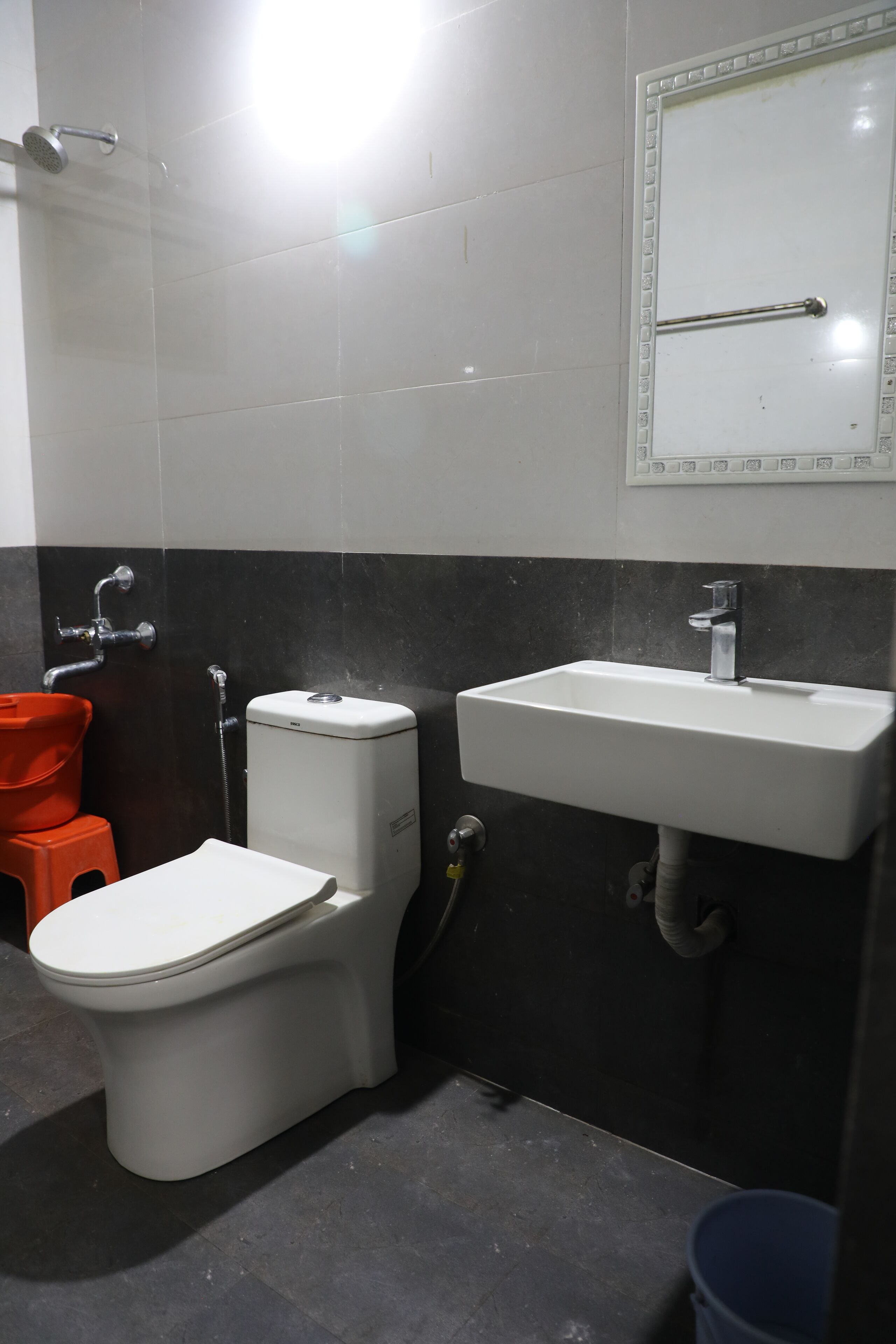 A bathroom with a toilet, sink, and shower.