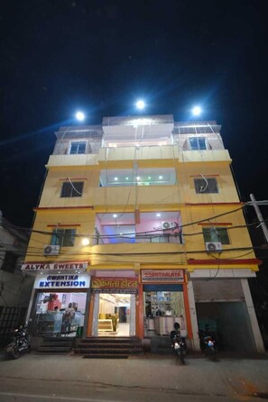 A multi-story building with several shops on the ground floor, including 'Alyka Sweets' and 'Rwantika Extension'. - Kamala Hotel (Deoghar)