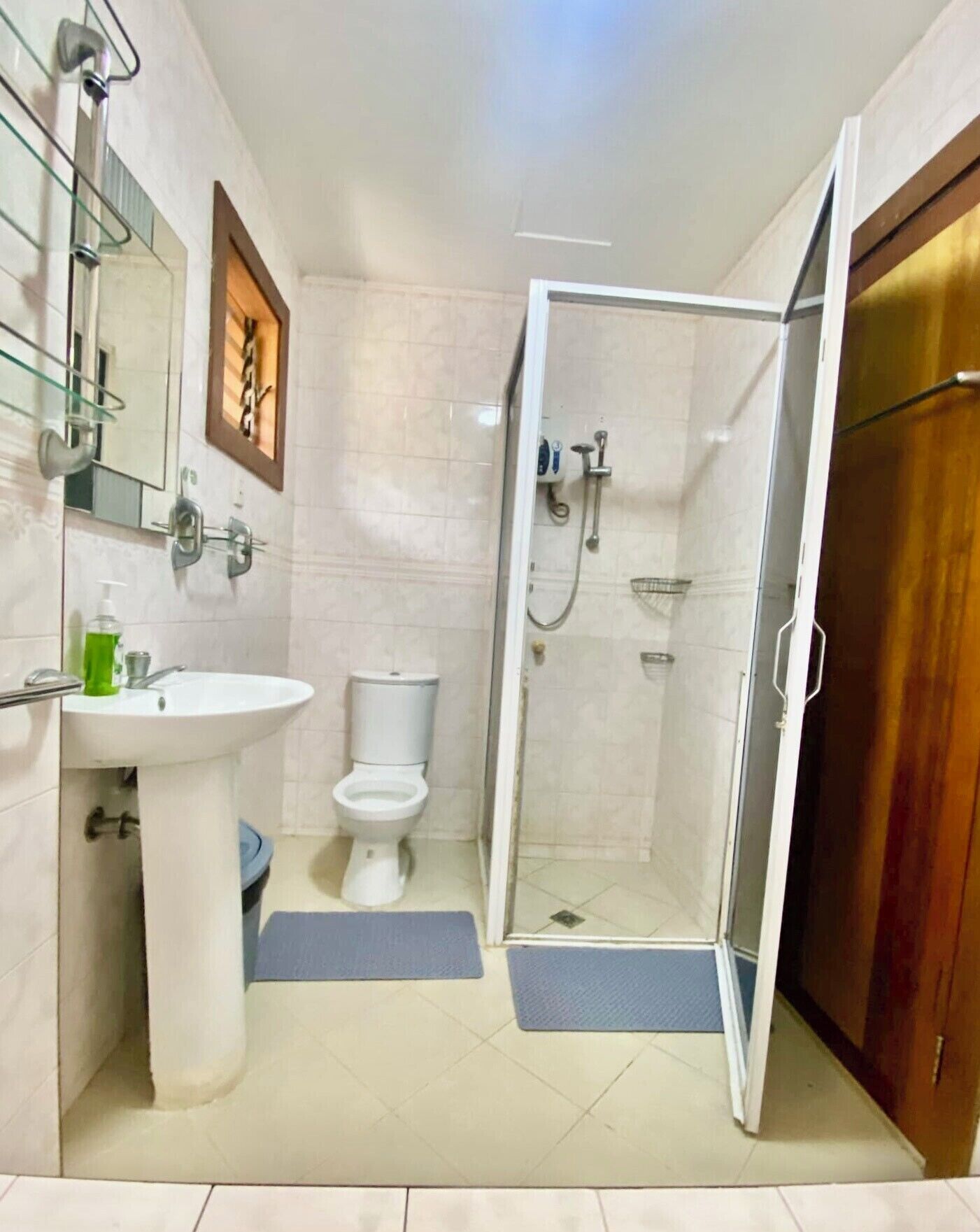 A bathroom with a sink, toilet, and shower area.