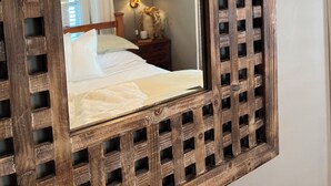A mirror with a wooden frame and a grid pattern.