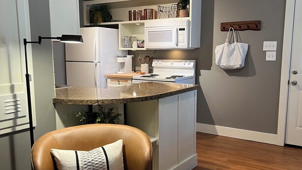 A modern kitchen with white appliances, a built-in microwave, and a countertop.