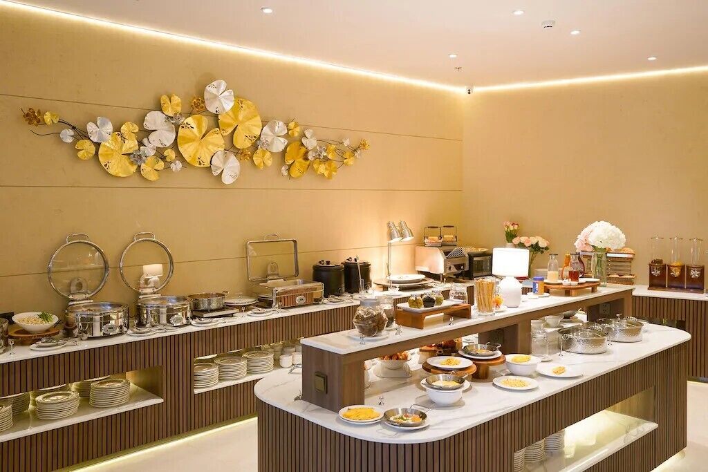 A buffet setup with various food items and serving dishes.