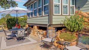 A patio with outdoor furniture, a table, and chairs. - 1/2 Mi to Lake Lawtonka: Mtn-View Haven! (Medicine Park)