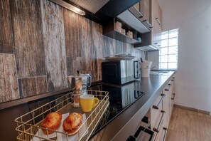 Fridge, microwave, stovetop, coffee/tea maker