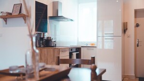 A modern kitchen with a built-in oven, a coffee machine, and a chalkboard menu on the wall. - Pop Art, Centre de Tours (Tours)