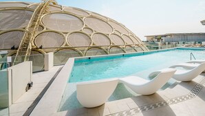 A modern pool area with a unique dome-shaped structure and a clear blue pool. - Cheval Maison Expo City Dubai (Dubai)
