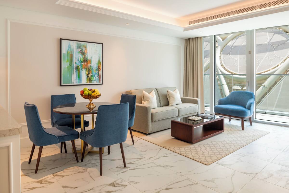 A modern living room with a dining area, a sofa, and a coffee table.
