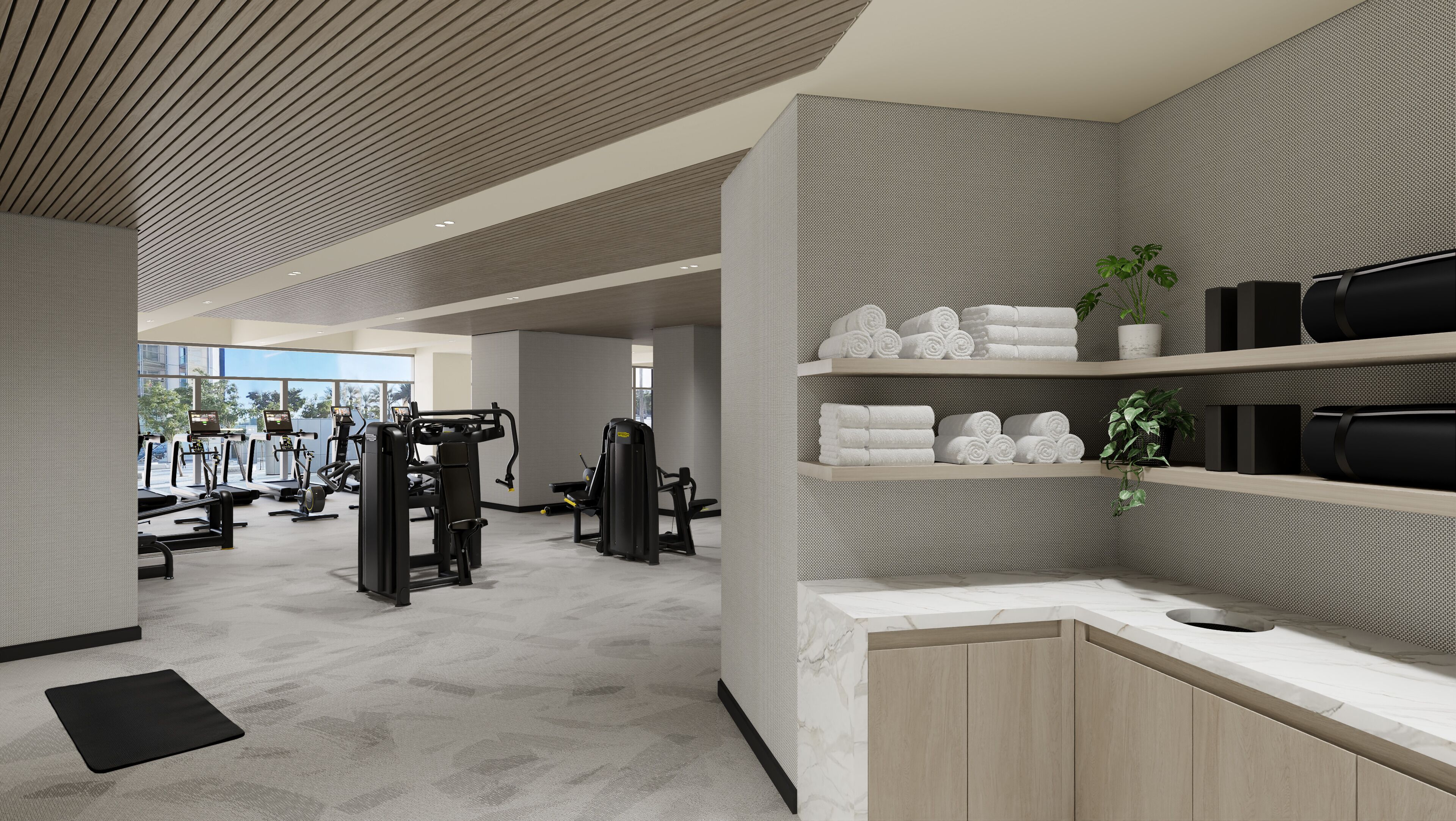 A modern gym with various exercise machines, a reception area with a counter and shelves, and a view of the outdoors.