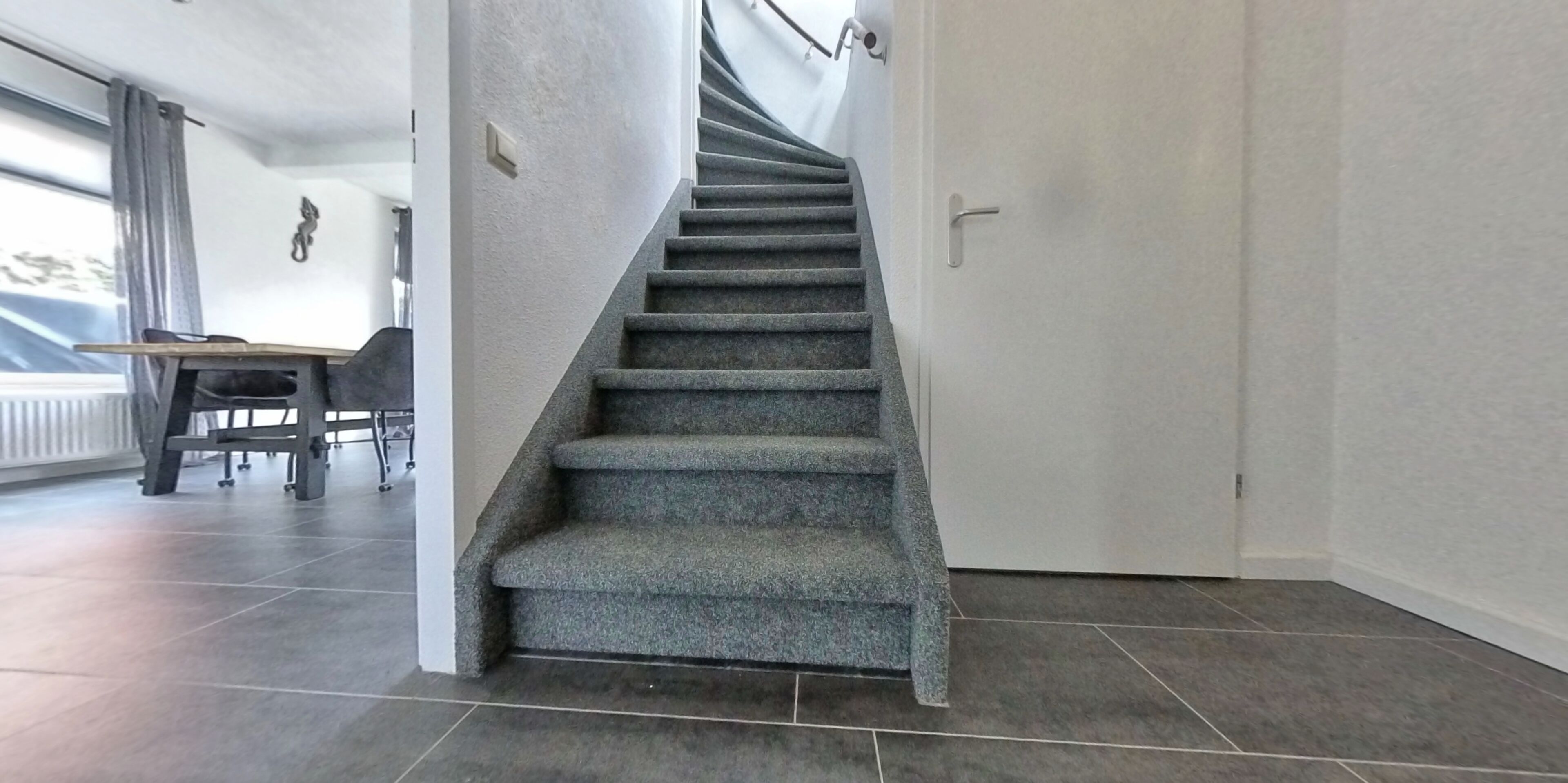 A staircase leading to a room with a view of the outdoors.