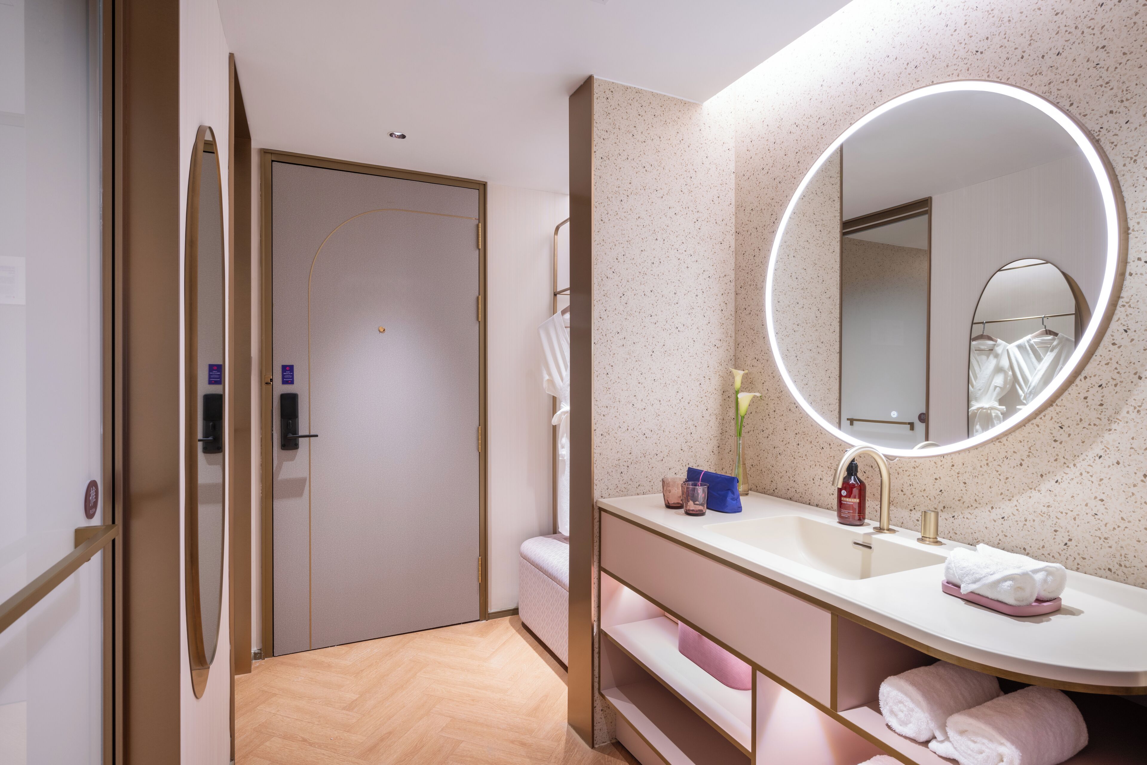 Un baño moderno con un espejo grande, un lavabo y un mueble de tocador.