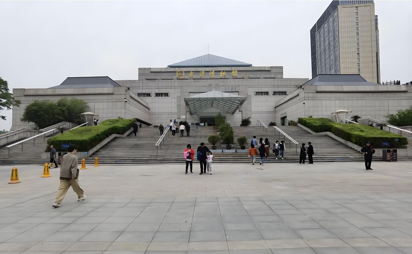 A large, modern building with a prominent entrance and wide steps leading up to it.
