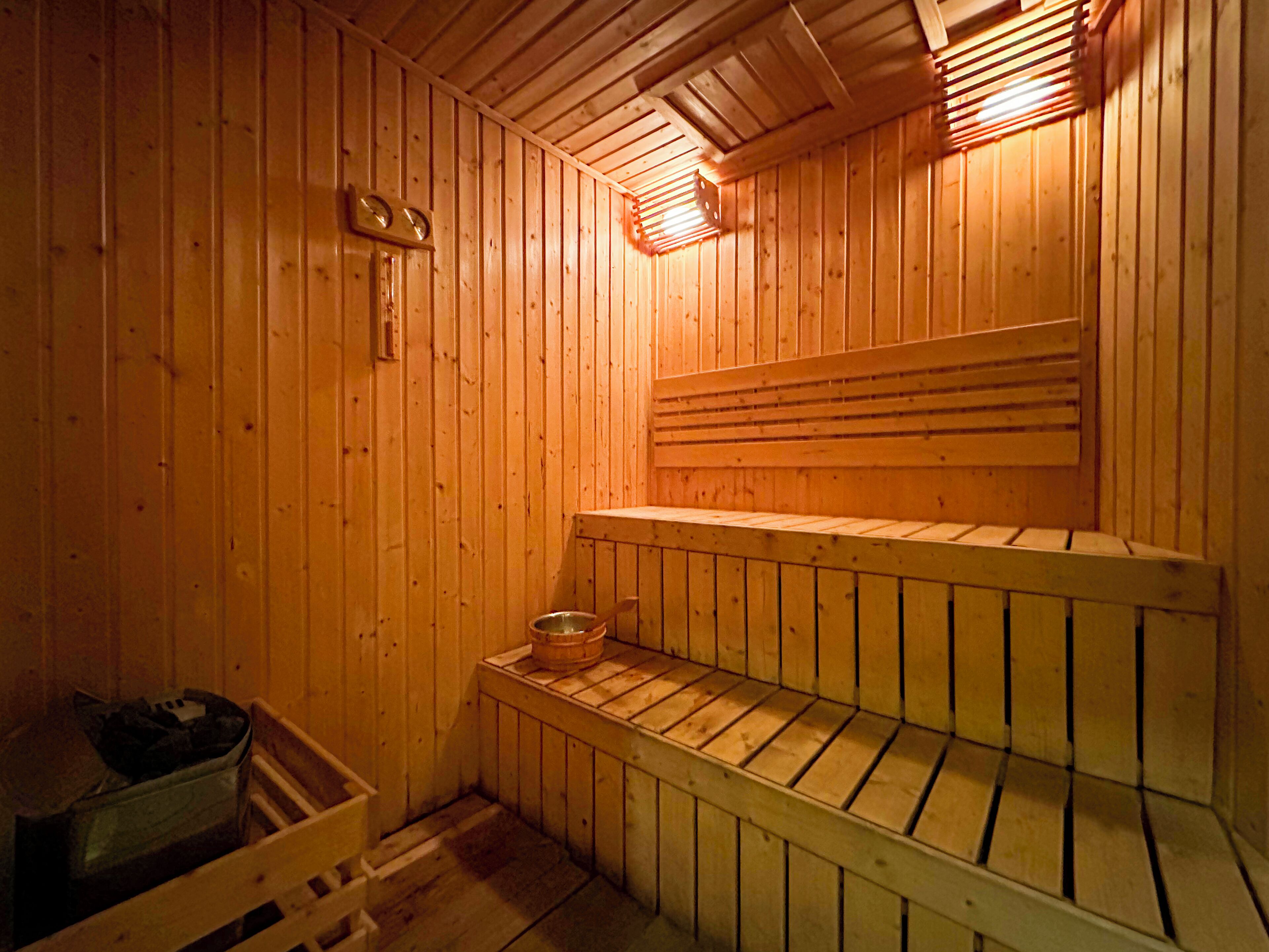 A sauna with wooden walls and benches.