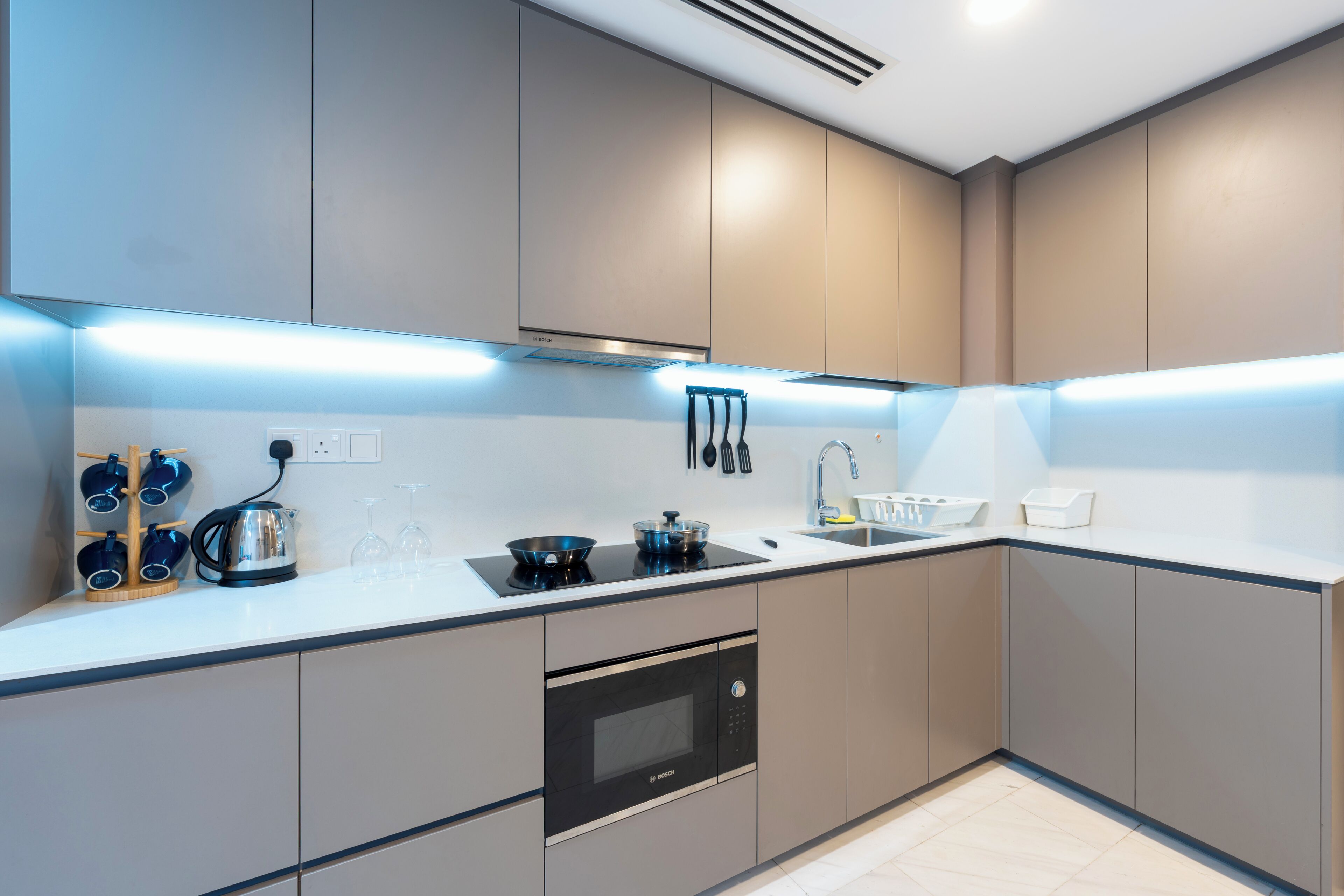 A modern kitchen with built-in appliances, a countertop, and a sink.