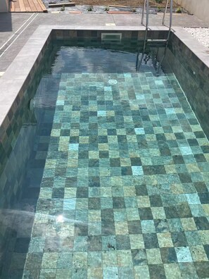 A swimming pool with a checkered tile pattern.