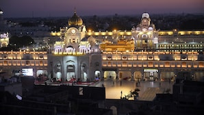 A large, illuminated building with multiple domes and arches, likely a historic or cultural landmark.