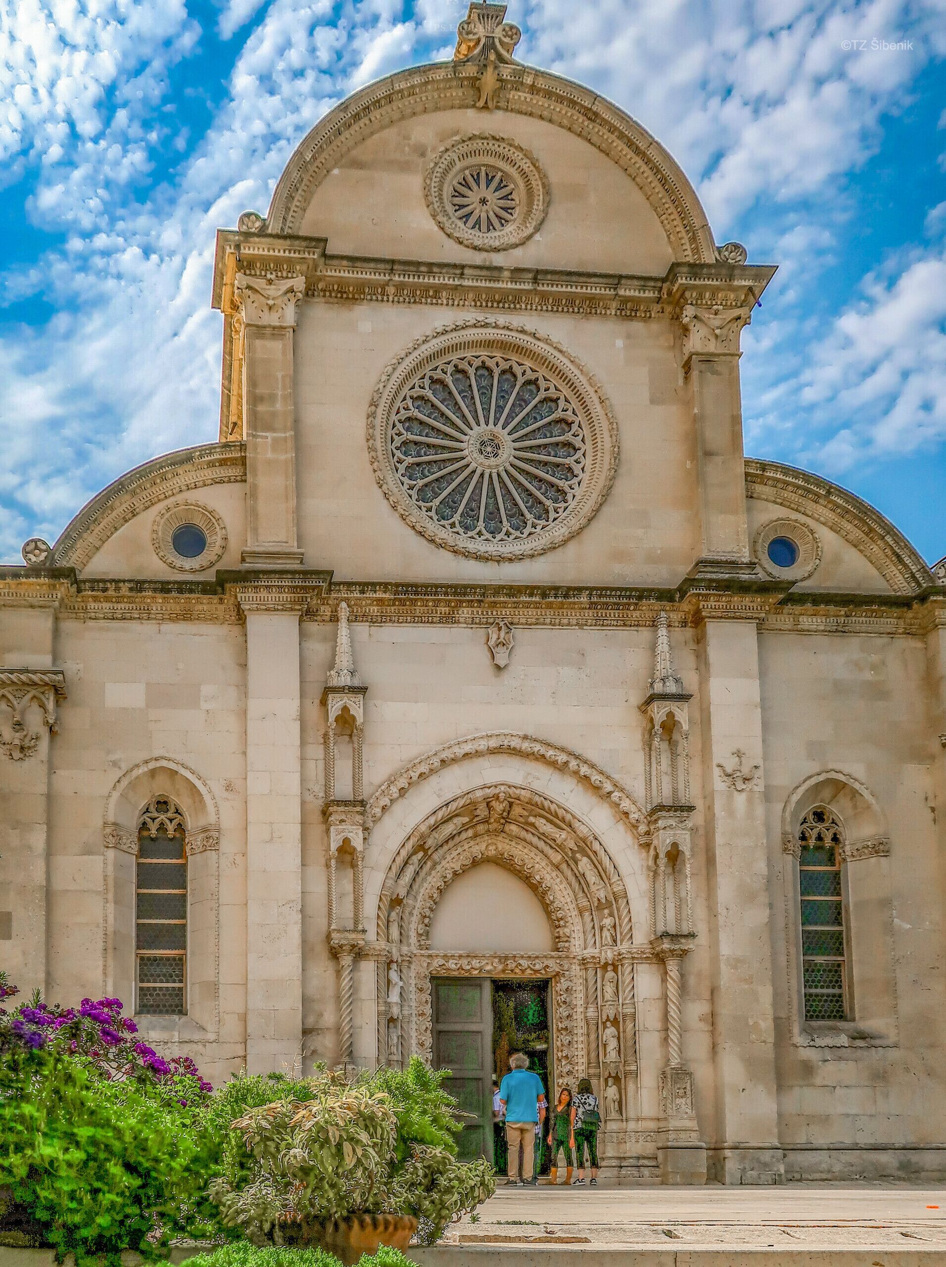 Un bâtiment historique doté d’une grande fenêtre circulaire et d’une entrée en arc de cercle.