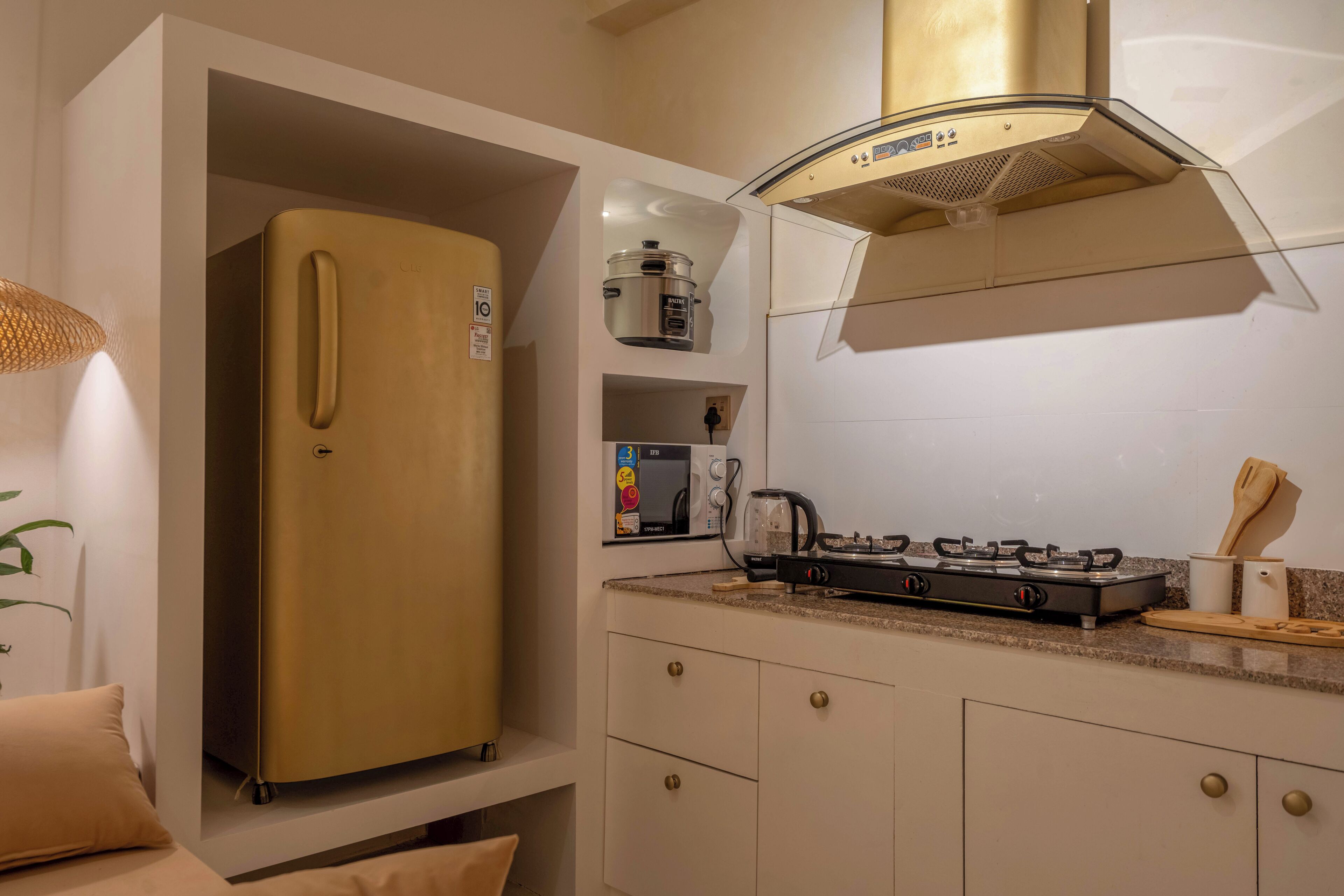 A compact kitchen with a built-in refrigerator, microwave, and gas stove.