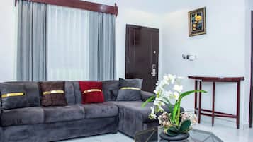 Luxury Single Room, Balcony | Living area | 42-inch flat-screen TV with digital channels