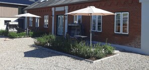 Guests can enjoy shaded seating and a convenient entrance at this charming building.