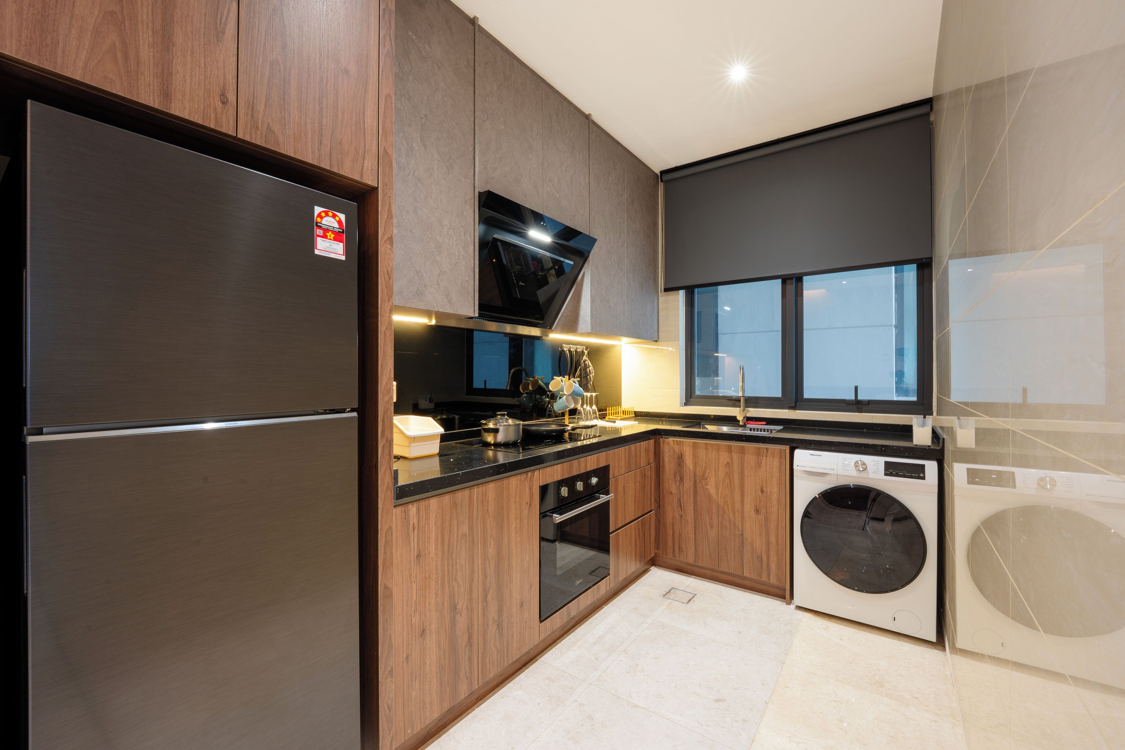 A modern kitchen with stainless steel appliances, wooden cabinets, and a built-in oven.