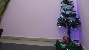 A hotel reception area with a wooden reception desk, a Christmas tree with lights and ornaments, and a sign above the desk reading "HOTEL 609 HOTEL SIXTY NINE". - Hotel Sixty Nine (Johor Bahru)