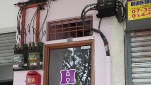 A hotel entrance with a glass door and a sign that reads "HOTEL". - Hotel Sixty Nine (Johor Bahru)