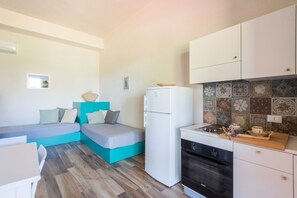 A compact room with a bed, a small kitchenette, and a dining area. - L Ulivo Blu - One-bed 2 With Seaview Balcony -loc (Castellammare del Golfo)