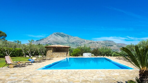 A pool area with stone flooring, lounge chairs, and a small stone structure. - L Ulivo Blu - One-bed 2 With Seaview Balcony -loc (Castellammare del Golfo)