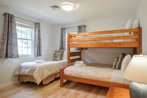 A room with two bunk beds, a window with curtains, a ceiling light, and a bedside lamp. - Waterfront on Follins Pond! (Dennis)