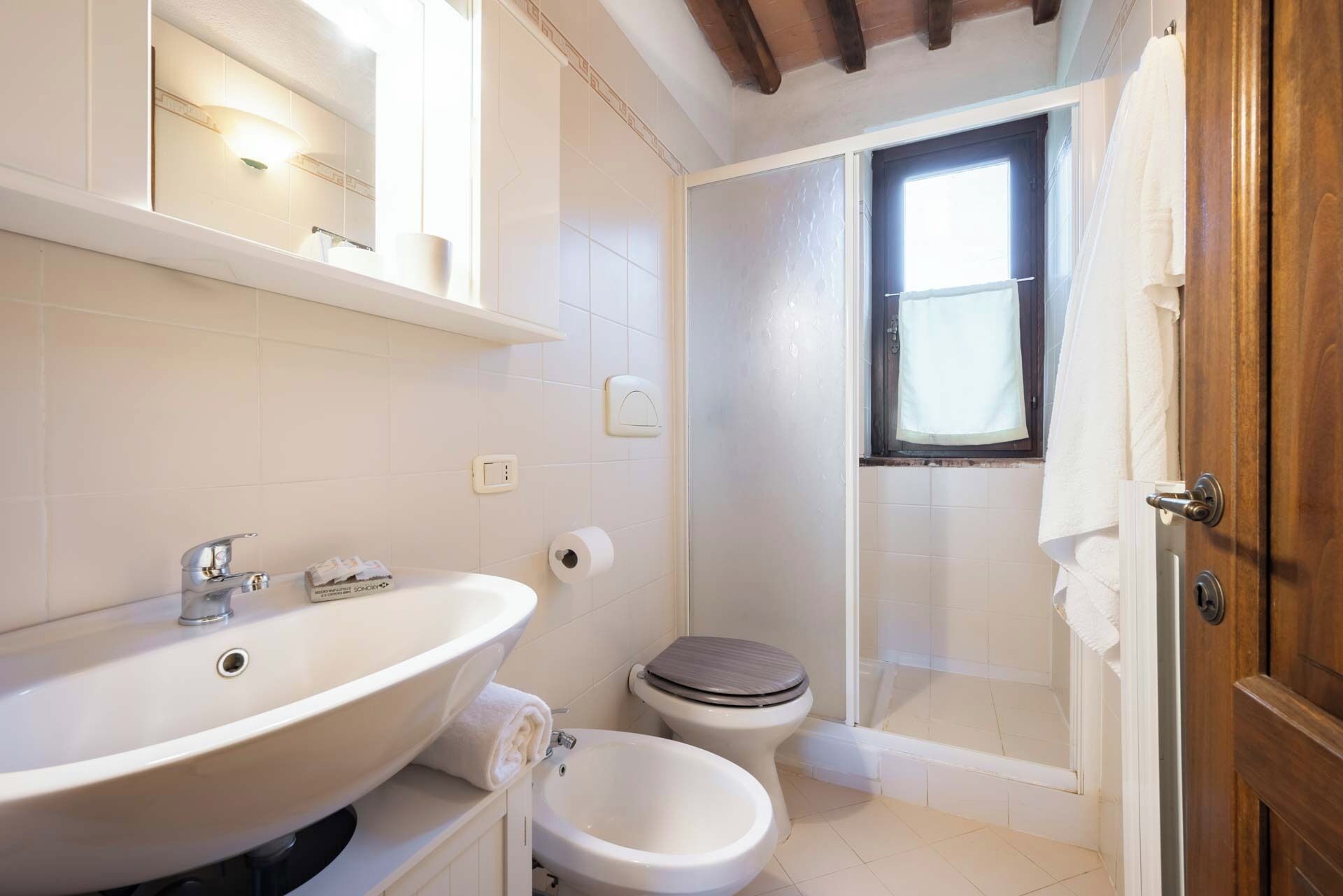 Un baño con lavamanos grande, inodoro y ducha.