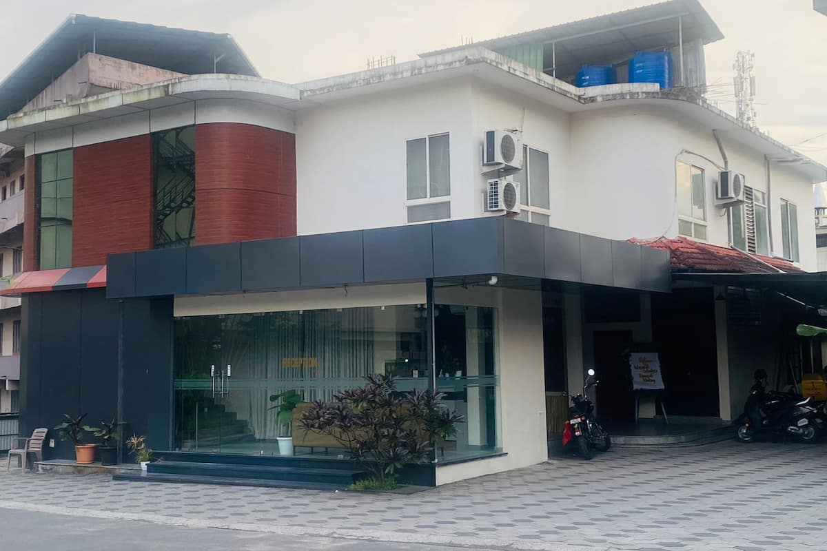 A modern building with a reception area, large windows, and air conditioning units.