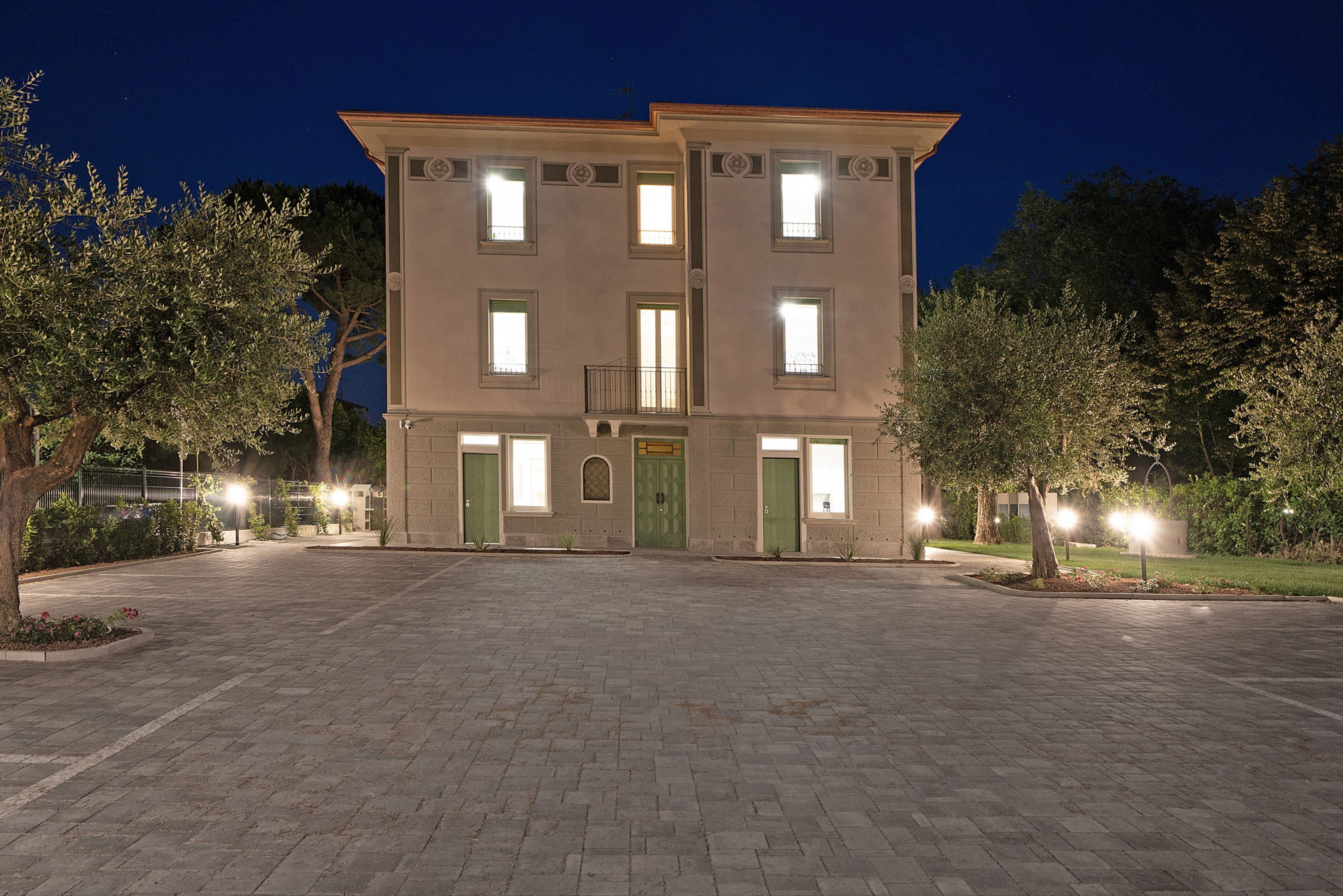 A two-story building with a central entrance and a small balcony.