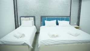 Family Triple Room, Courtyard View | Desk, laptop workspace, free WiFi, bed sheets