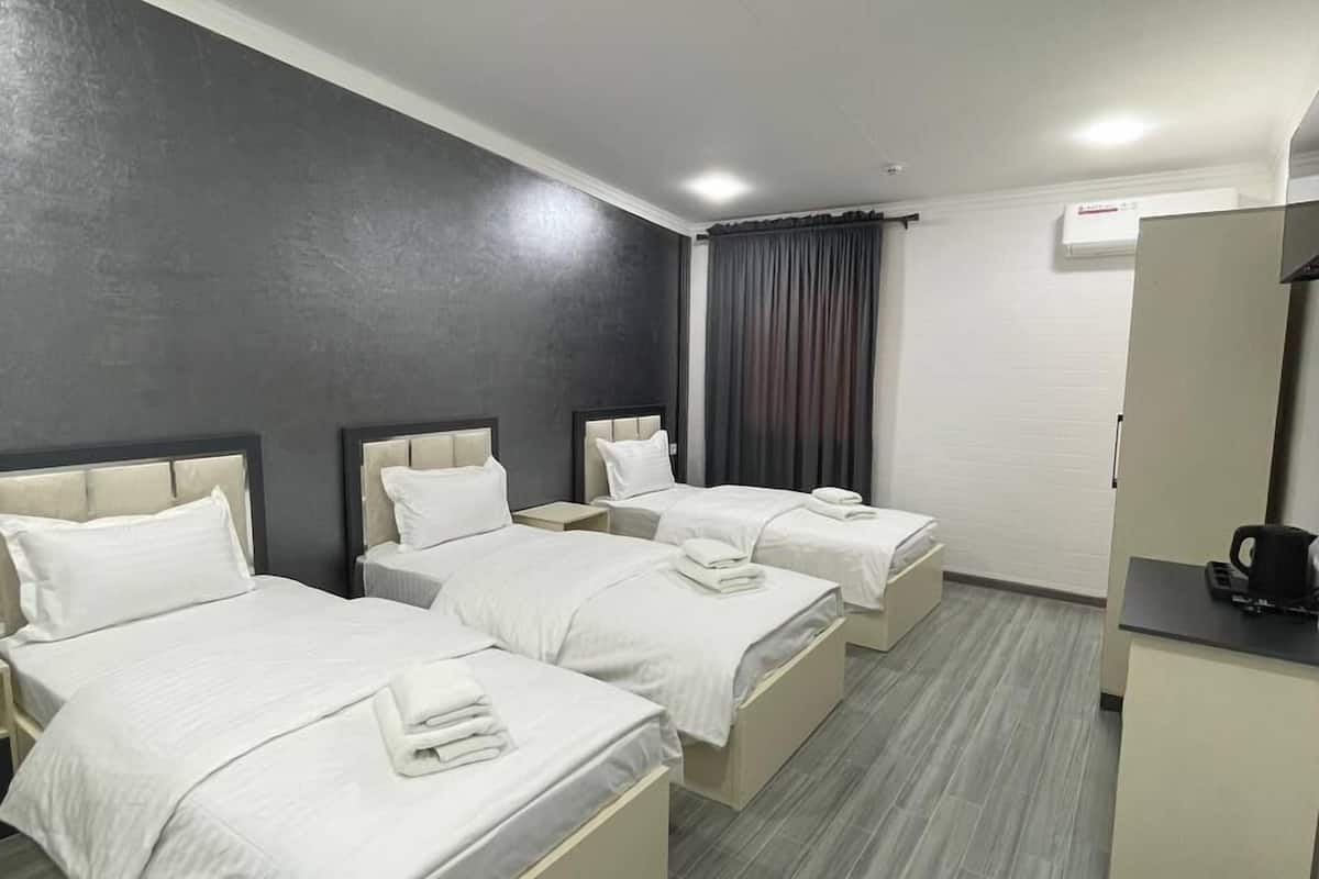 Family Triple Room, Courtyard View | Desk, laptop workspace, free WiFi, bed sheets