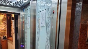 An elevator with a patterned door and a metal handle. - Martin City Hotel (Bursa)