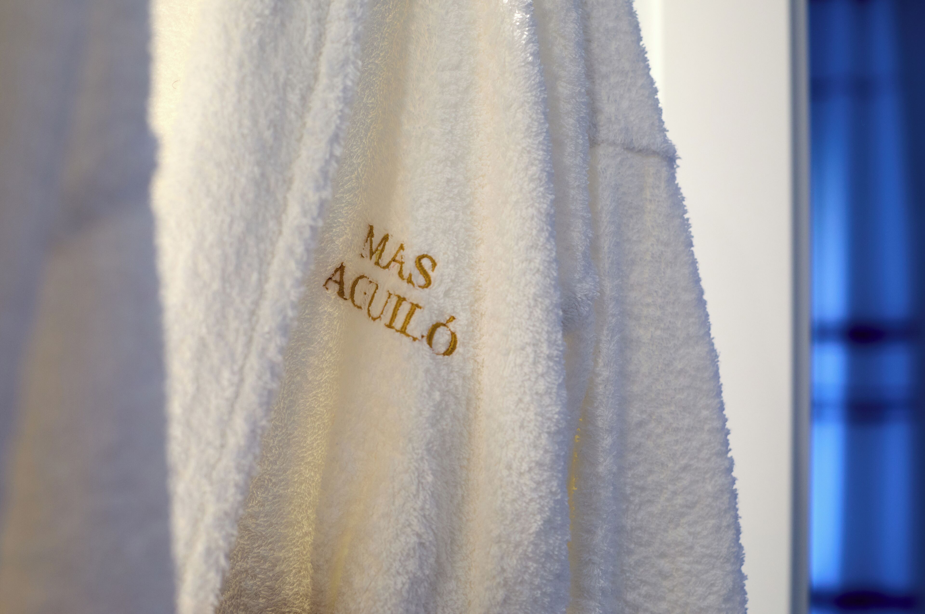 A white towel with embossed text.