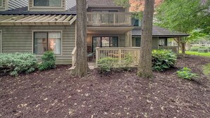 A two-story house with a covered porch and a small garden area. - Richmond Pk 14E in Kingston 2nd floor, Pool, Beach (Myrtle Beach)