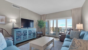 A living room with a television, a cabinet, a coffee table, and a sofa. - Sandy Key 123:  2 BR / 2 BA Gulf Front Condo in Perdido Key, FL  Sleeps 6 (Pensacola)