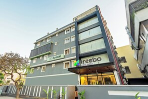 A multi-story hotel with a modern facade, a visible entrance, and a sign for 'treebo Hydotel Kompally'. - Treebo Hydotel Kompally (Hyderabad)