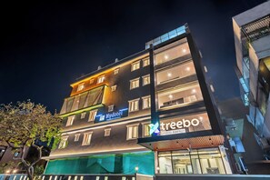 A multi-story building with a 'Hydotel' sign and a 'treebo' sign, indicating a hotel and a company. - Treebo Hydotel Kompally (Hyderabad)
