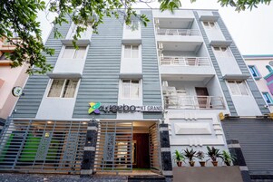 Un edificio de varios pisos con un letrero que dice "treebo - KT GRAND".