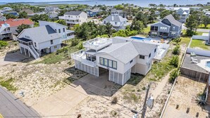 A coastal residential area with houses, a swimming pool, and a beach. - Book A Key West Heart | Semi-Oceanfront Sandbridge Rental (Virginia Beach)