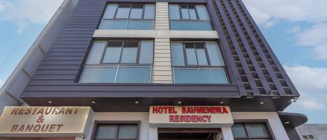 A hotel named 'HOTEL SAUMENDRA RESIDENCY' with a sign indicating a restaurant and banquet facility.