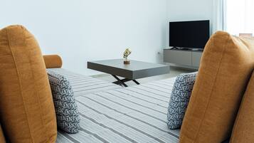 Villa, Pool View | Living area | 35-inch TV with digital channels