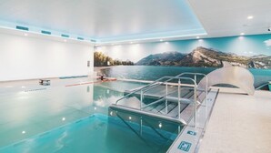 An indoor swimming pool with a view of mountains and a lake. - Cozy chalet in the Swiss Alps with Heidi bed. Pet friendly! (Amden)