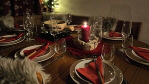 A dining table set for a meal with plates, cutlery, and glasses. - Cozy chalet in the Swiss Alps with Heidi bed. Pet friendly! (Amden)