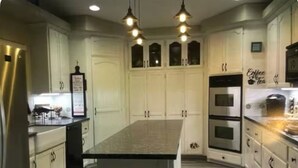 A modern kitchen with white cabinetry, a central island, and stainless steel appliances. - Driftwood Cove Lake House – Waterfront, Pet-Friendly, Private Dock in Helendale (Helendale CA)