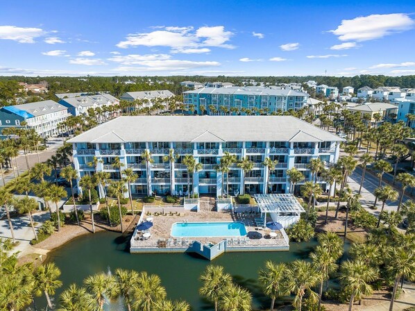 A large hotel with multiple floors, a central courtyard, and a pool area.