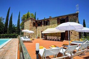 Relax by the pool surrounded by lush greenery and enjoy dining al fresco.