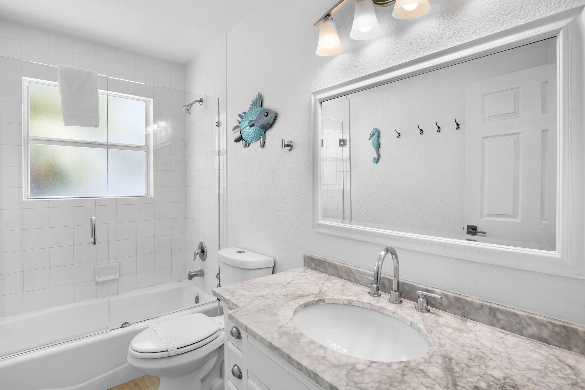 A bathroom with a bathtub, toilet, and sink.